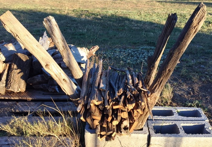 kindling dryer made from old fence posts and cinder blocks