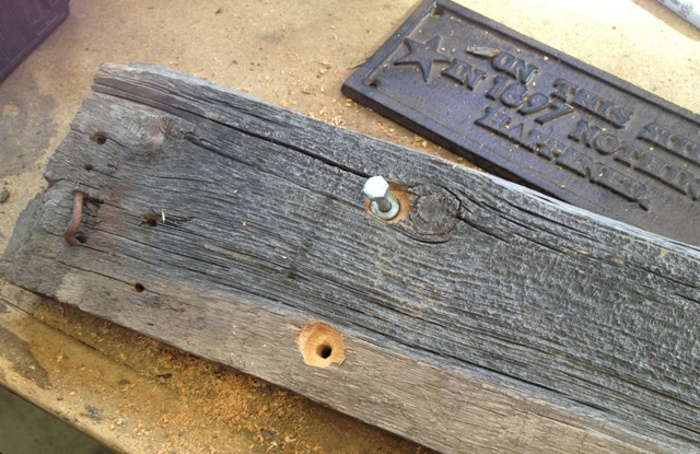 marking the holes in the sign for the post